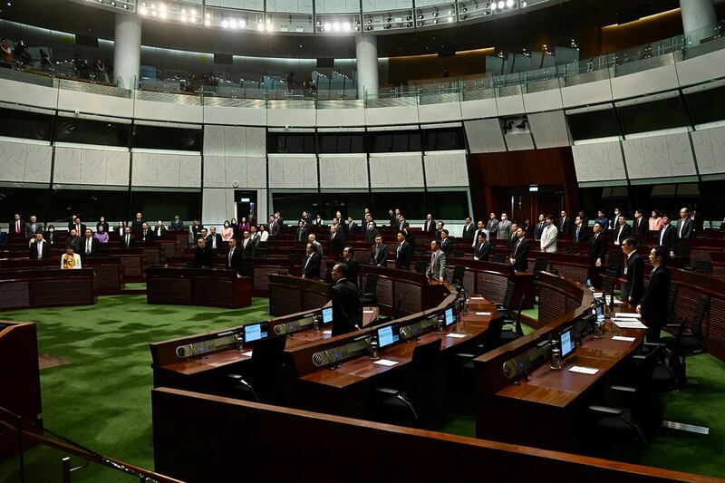 Lawmakers take part in reading the draft of the Safeguarding National Security Bill at the Legislative Council in Hong Kong on March 8, 2024. (Li Zhihua/China News Service/VCG via Getty Images)