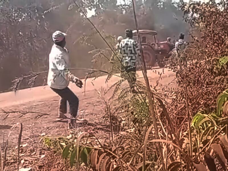 A man throws a rock at a Santana Agro Products Co. tractor in an attempt to prevent Santana Agro Products Co. from clearing their forest and destroying their farmlands in Preah Vihear province, Cambodia, Jan. 28, 2025.