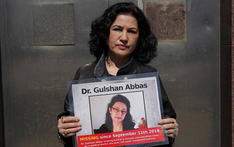 Rushan Abbas, executive director of the Campaign for Uyghurs, holds a photo of her sister, who is imprisoned in a Chinese camp, during a rally in New York on March 22, 2021.