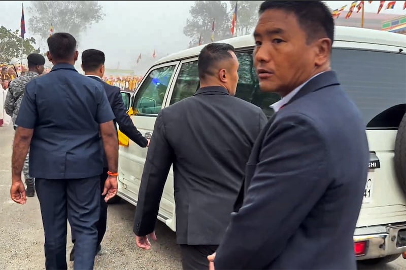 The vehicle transporting the Dalai Lama is guarded by the Central Reserve Police Force in Hunsur, Karmataka, India, Feb. 18, 2025.