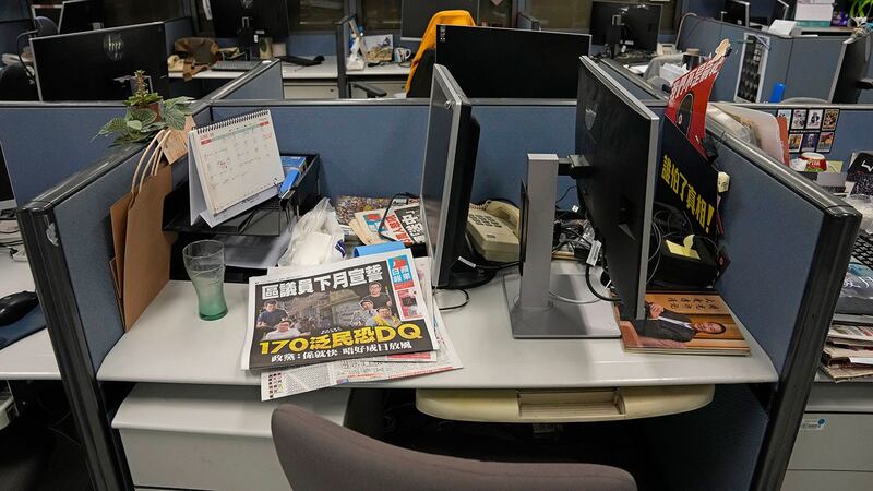 资料图片:2021 年 6 月 17 日,香港警方在《苹果日报》总部的新闻编辑室没收了相应的计算机作为证据后,监视器仍然存在。(美联社)