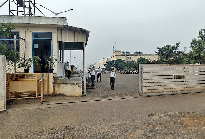 2021年12月22日,私人保安站在印度钦奈附近为苹果公司生产 iPhone 的富士康印度分公司一家工厂的入口处。(路透社)