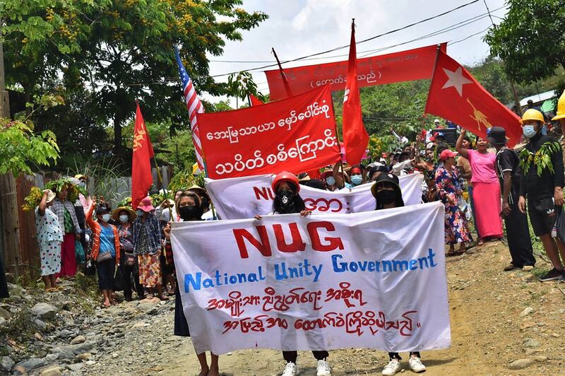 Protesters marching with banners supporting National Unity Government during a demonstration against the military coup in Hpakant in Myanmar's Kachin state, May 8, 2021. Credit: Kachin Waves via AFP