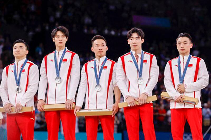 The Chinese men's gymnastics team on the podium at the Paris Olympics, July 29, 2024. (Reuters)