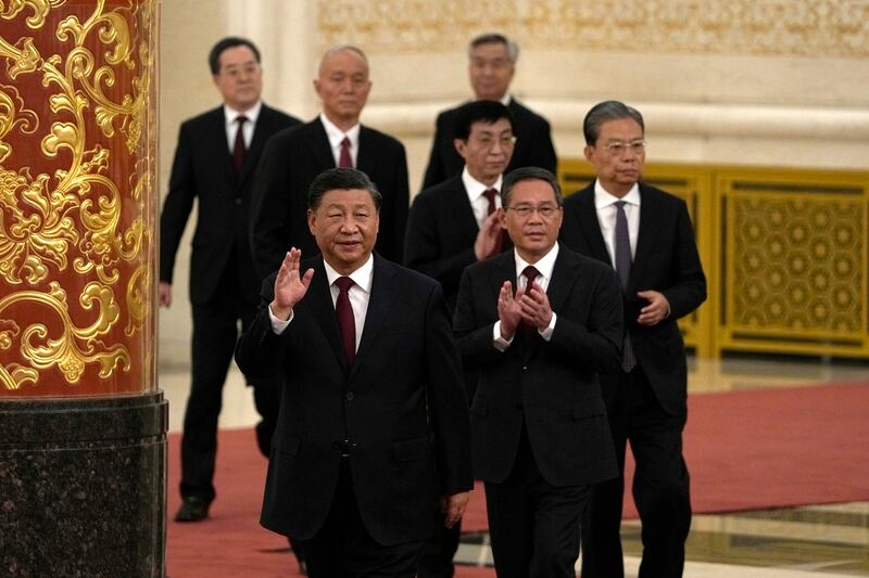 New members of the Politburo Standing Committee, front to back, President Xi Jinping, Li Qiang, Zhao Leji, Wang Huning, Cai Qi, Ding Xuexiang, and Li Xi arrive at the Great Hall of the People in Beijing, Sunday, Oct. 23, 2022. Political commentator Cai Shenkun believes Xi worries that one of the Politburo members could one day take him down. Credit: Associated Press