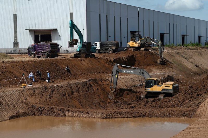 Workers use excavators during the construction of the Funan Techo canal in Kandal province, July 9, 2024. (Tang Chhin Sothy/AFP)