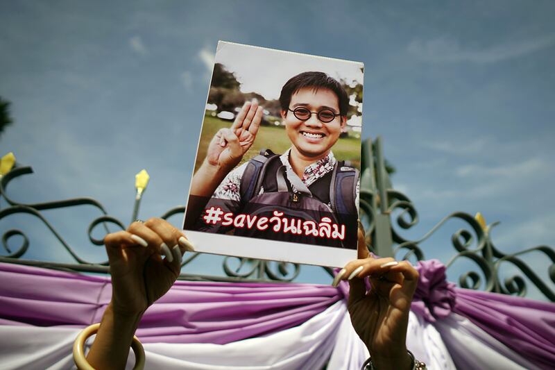 An activist holds up a picture of Thai activist Wanchalearm Satsaksit at a protest calling for an investigation, in Bangkok, June 12, 2020.