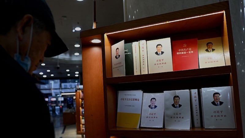 2021 年 11 月 8 日,一名男子在北京一家书店看有关中国国家主席习近平的书籍。(法新社)