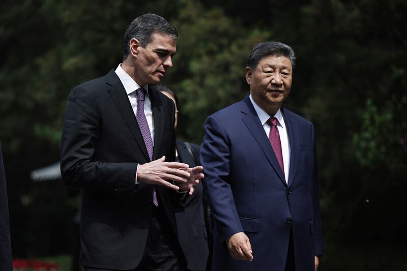 Spanish Prime Minister Pedro Sanchez and Chinese President Xi Jinping speak as they walk along the gardens of Diaoyutai Guest House after a meeting in Beijing, China, 11 April 2025. ANDRES MARTINEZ CASARES/Pool via REUTERS