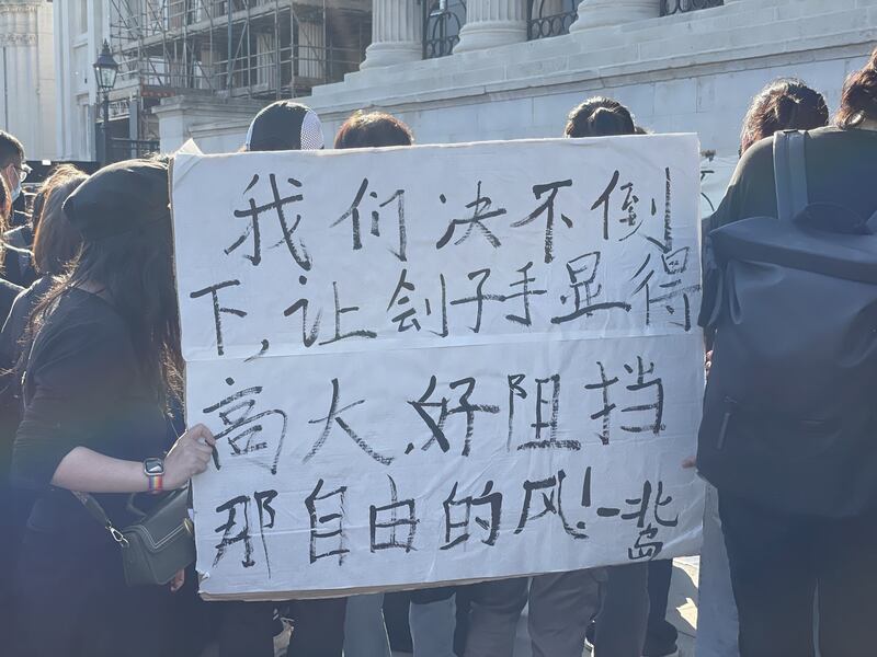 不少中国留学生手持鲜花和自制标语,默默加入集会。(吕熙拍摄)