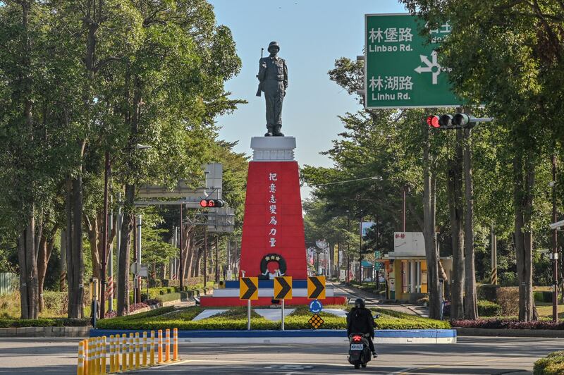 This Dec. 7, 2023 image shows a statue with a banner that reads "Turn your Will into Strength" in Kinmen. It is one of many reminders of the conflict decades earlier with Chinese communist forces. (Sam Yeh/AFP)